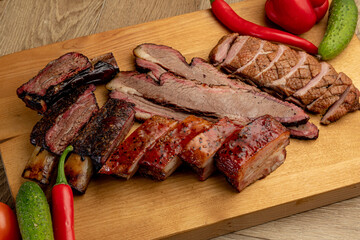 assorted smoked meats served on a wooden tray