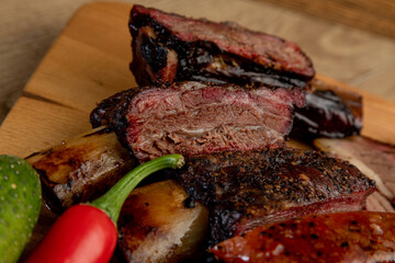 assorted smoked meats served on a wooden tray