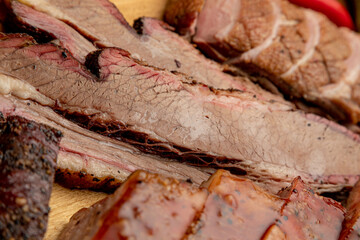 assorted smoked meats served on a wooden tray
