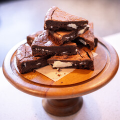 A stack of chocolate brownies on wooden background, homemade bakery and dessert