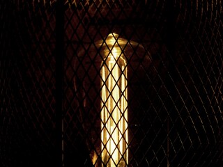 A decorative lamp brightens up a dark room. Light triumphs over darkness.
