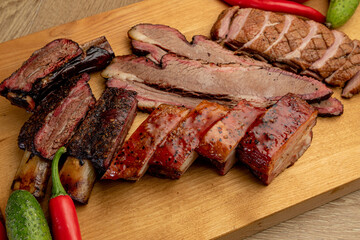assorted smoked meats served on a wooden tray