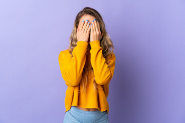Young Brazilian woman isolated on purple background covering eyes by hands