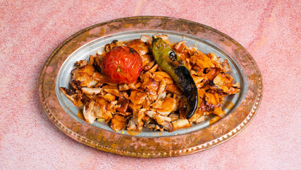 Chicken iskender doner kebab in copper plate isolated