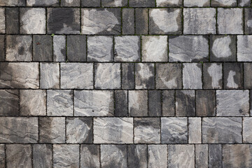 perpendicular view of a pavement of rectangular stone tiles of various sizes