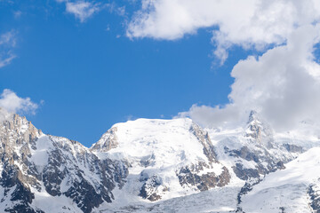 Fototapeta na wymiar Mont Blanc du Tacul hidden by clouds in the Mont Blanc Massif in Europe, France, the Alps, towards Chamonix, in summer, on a sunny day.