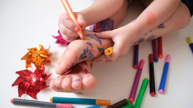 Funny cute bare feet. Child painting coloring feet
