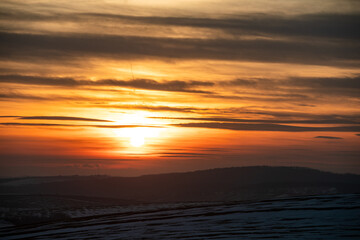sunset over winter snowed field