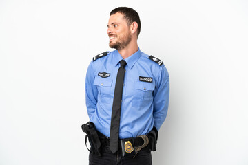 Young police Brazilian man isolated  on white background looking side