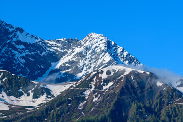 The close-up on the snow-capped Mont Lachat in the Mont Blanc Massif in Europe, France, the Alps, towards Chamonix, in summer, on a sunny day.