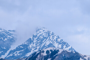 Mont Lachat at nightfall in the fog in the Mont Blanc Massif in Europe, France, the Alps, towards...