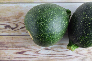 Zenith view, round zucchini on rustic boards, copy space.