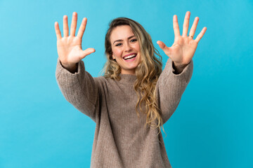 Young Brazilian woman isolated on blue background counting ten with fingers