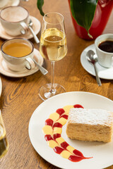 delicious dessert napolon served with champagne. photo of dessert in the interior.