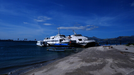 Obraz premium Refurbished cruise passenger yacht docked on the beach