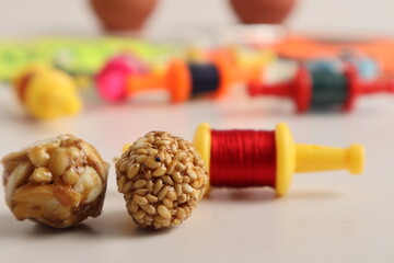 Indian festival makar sankranti concept, Sesame seed ball or til ke laddo with Kite String