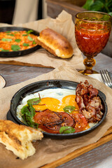 breakfast of omelet, eggs fried with bacon. Served with fresh pastries and drinks