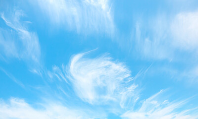 Fototapeta na wymiar Blue sky and white clouds background - Pillowy clouds cover a blue sky in the background