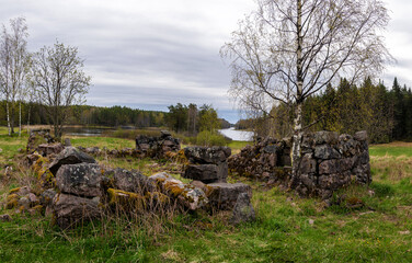 Ruins of an old Finnish stone foundation in a forest in Karelia © Andrey