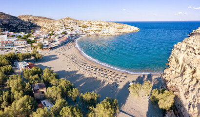 Sunrise over the empty beach of Matala seaside resort town, Crete, Greek Islands