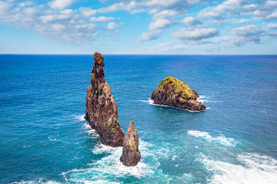 Aerial view of rock formation Ilheus da Rib and Ribeira da Janela in the rough ocean, Porto Moniz, Madeira island, Portugal, Atlantic