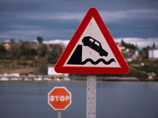 Horizontal view of warning traffic sign of end of road and fall into the sea.