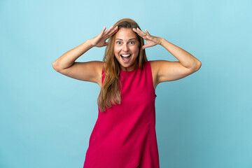 Middle age brazilian woman isolated on blue background with surprise expression
