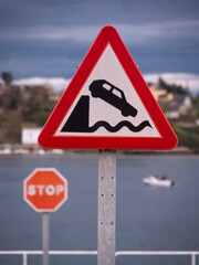 Warning traffic sign of end of road and fall into the sea.