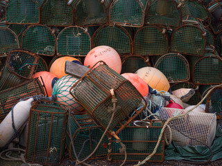 Ribadeo, Galicia, Spain. Close up view of row of octopus traps and orange and white buoys in the...