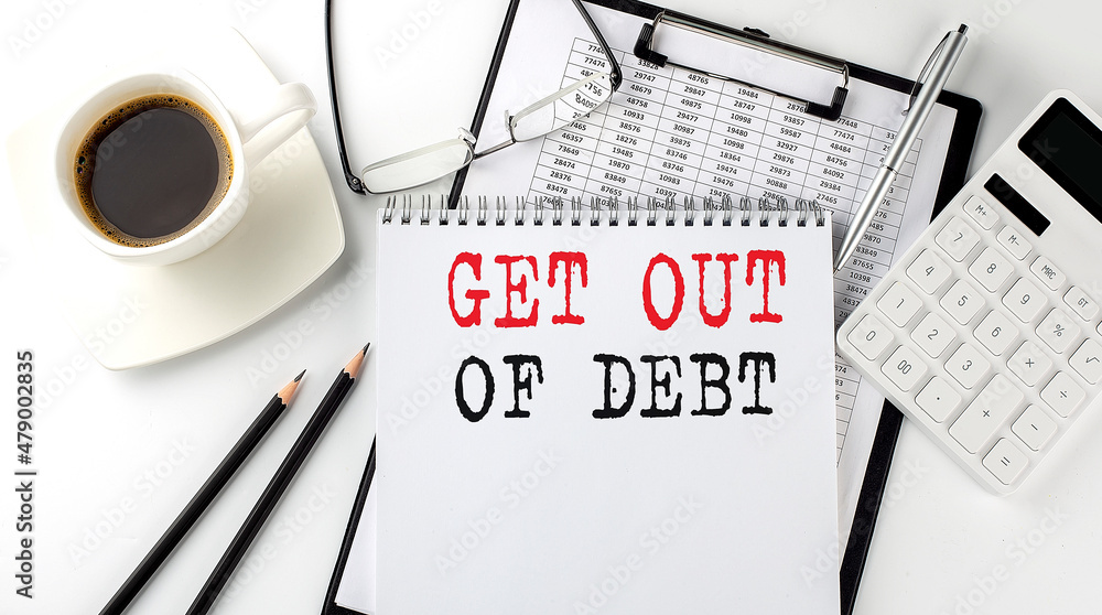 Poster get out of debt text on the paper with calculator, notepad, coffee ,pen with graph