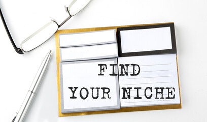 FIND YOUR NICHE text on the sticky notes with glasses and pen, business concept