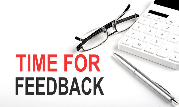 TIME FOR FEEDBACK Concept. Calculator,pen and glasses on white background