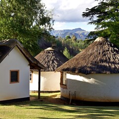 Rondawels or round huts at Lake Saint Bernards in the Natal Midlands of South Africa over looking a distant mountain view