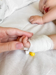 Mother holding child's hand who fever patients in hospital to give encouragement.