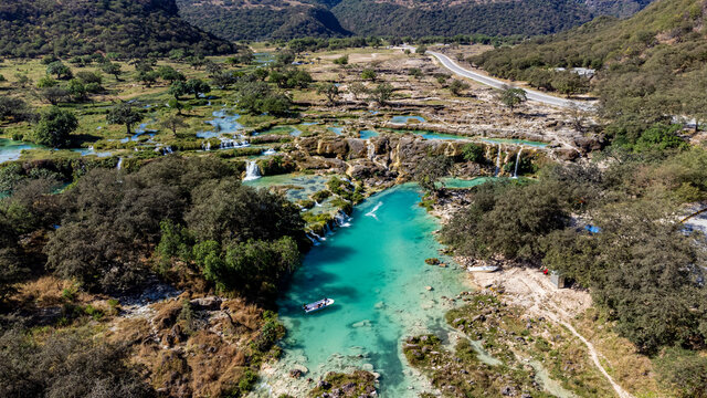 Aerial of turquoise waterfalls, Wadi Darbat, Salalah