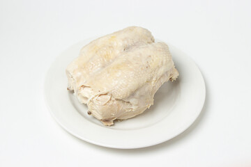 Boiled chicken breast on a white background. Diet meat on a white plate. Healthy diet