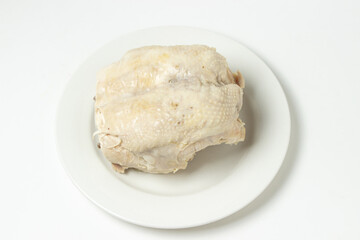 Boiled chicken breast on a white background. Diet meat on a white plate. Healthy diet