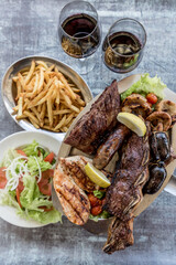 Complete barbecue with salad, fries and wine