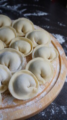 Fototapeta na wymiar dumplings, a traditional dish of Russian cuisine, made of dough stuffed with minced meat, minced meat, cooking process, modeling, recipe