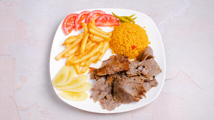 Portion pilaf beef doner kebab with french fries isolated