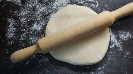 cooking process, modeling, recipe, dough, roll out with a wooden rolling pin, flour
