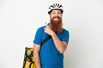 Young reddish caucasian man with thermal backpack isolate don white background pointing to the side to present a product