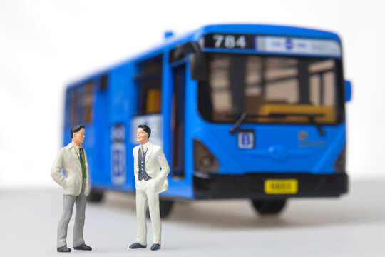 Business man standing in front of public transport bus