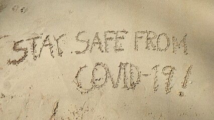 Write text letters on the sandy beach.