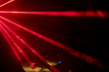 Bright red neon laser lights illuminate the darkness creating lines and triangle shapes in sci-fi...