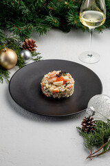 Fototapeta na wymiar Olivier salad with red caviar, on a light Christmas background. traditional Russian dish for the New Year and Christmas.
