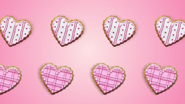 two lines with Heart shape ginger breads decorated with pink and white sugar glazing animated in different direction on a pink background. Love concept for mother's, St. Valentine's and women's day