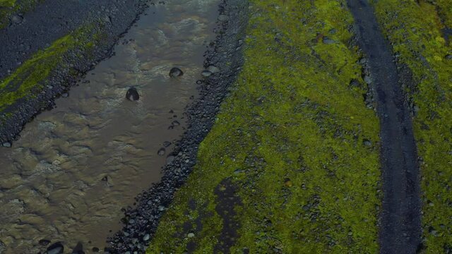 Aerial vertical panoramic view of water flow and road