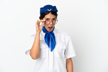 Airplane stewardess caucasian woman isolated on white background with glasses and surprised
