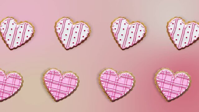 two lines with Heart shape ginger breads decorated with pink and white sugar glazing animated in different direction on a pink background. Love concept for mother's, St. Valentine's and women's day